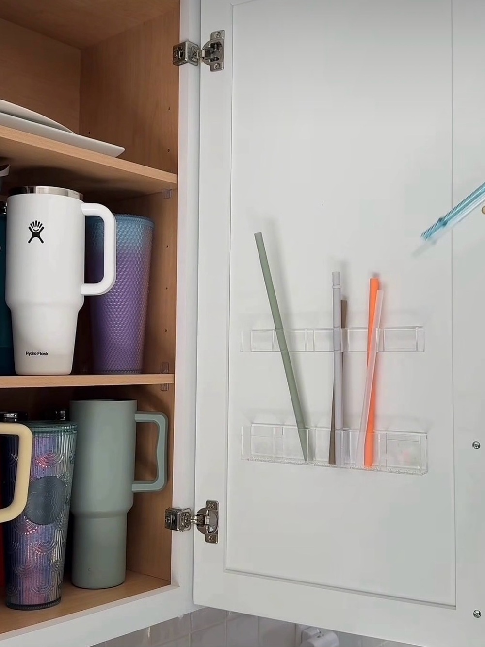 Clear straw holder mounted on cupboard door